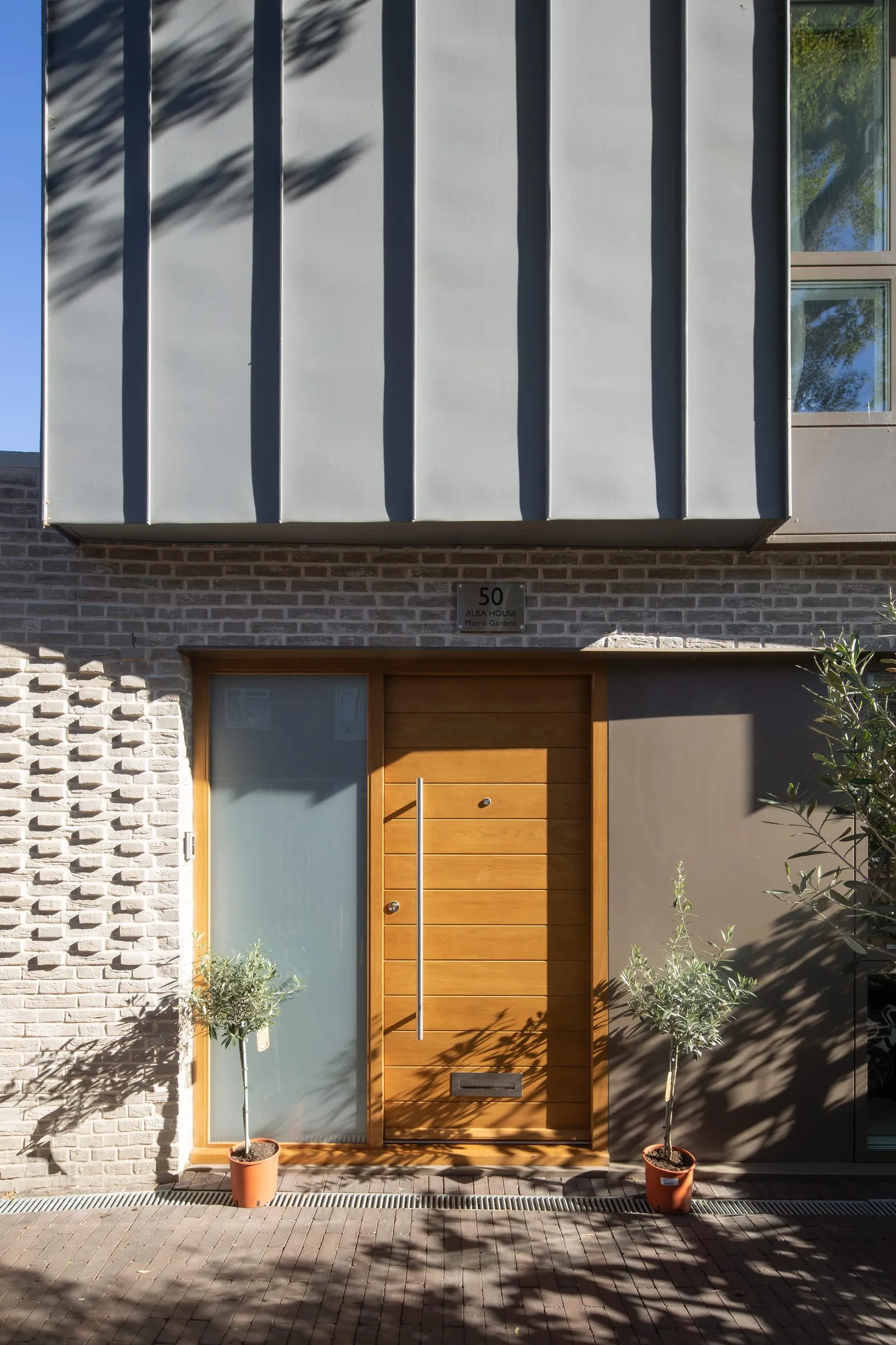 New-build house with zinc-clad upper storey and handmade brick facade, built by the Chat to Your Builder team